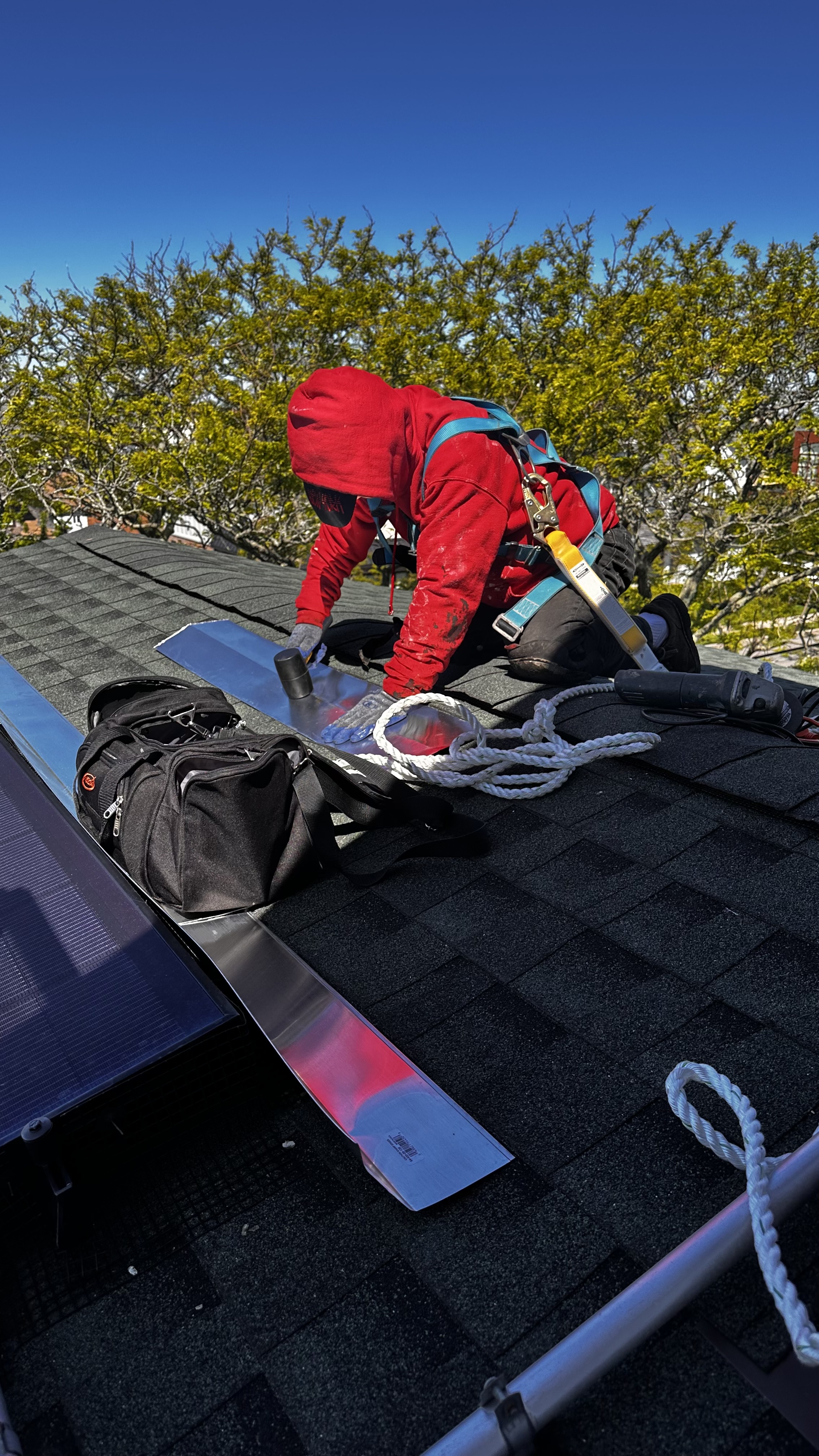 Roofer working on shingle installation